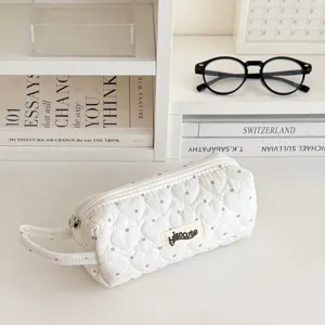 Quilted pencil pouch detail, white fabric with cute gray polka dots, portable handle.