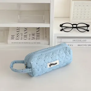 Blue quilted pencil case with cute heart pattern, portable handle design, perfect school stationery.
