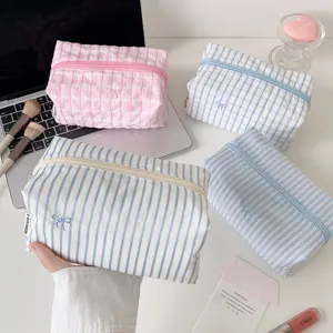 Large capacity cute striped grid cosmetic bag and pencil pouch with delicate bow embroidery detail.