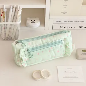 Green canvas pencil case featuring cute pink stars, ruffles and star-shaped zipper pulls.