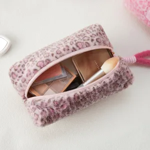 Detail shot of fluffy pink leopard print cosmetic bag interior, soft plush pouch with makeup storage.