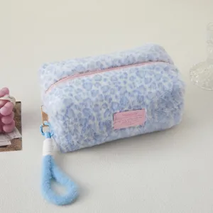 Detailed view of blue plush leopard print pencil case, fluffy texture and pink zipper.