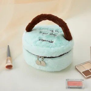 Fluffy round mint green cosmetic bag with brown handle, cute plush makeup travel organizer.