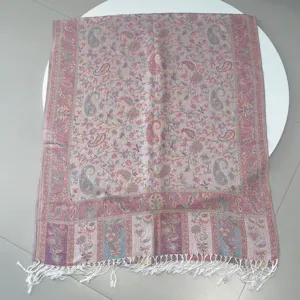 Full view of elegant pink paisley jacquard scarf featuring white tassel fringe details