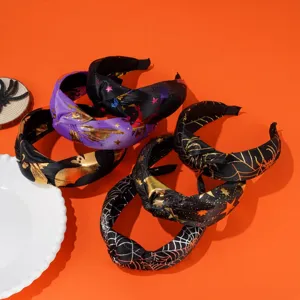 Halloween knotted headbands with bat and spider web patterns on orange backdrop
