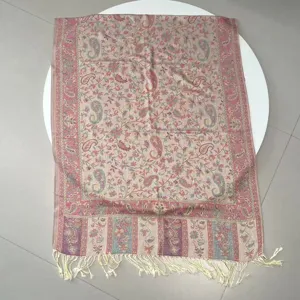Detailed view of ethnic paisley jacquard shawl with decorative fringe tassels