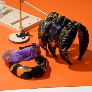 Detailed view of Halloween knotted headbands with gold bat and spider web patterns