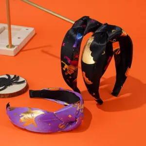Detailed view of Halloween knotted headbands with gold bat and star prints
