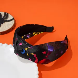 Detailed view of Halloween wide knotted headband with colorful star and moon patterns