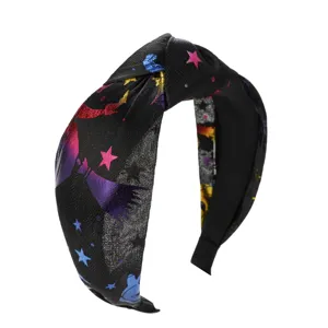 Close-up of Halloween wide knotted headband with metallic star and moon prints
