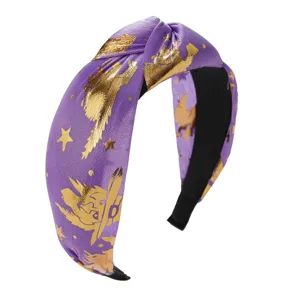 Detail view of purple Halloween knotted headband with gold foil witch print
