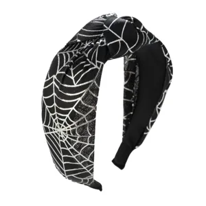 Detail view of a black knotted headband with a silver spiderweb pattern for Halloween.