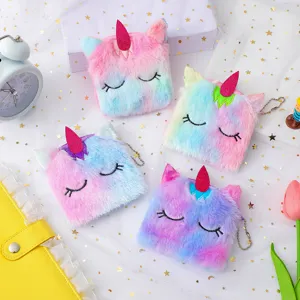 Close-up detail of cute cartoon unicorn plush coin purses with colorful gradient fur.