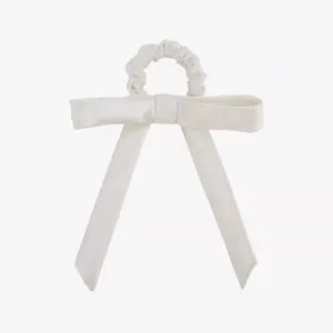White satin bow scrunchie detail shot, elegant hair tie accessory for women and girls daily.