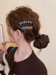 Detailed shot of retro polka dot and heart design hair clips, worn on side hair elegantly.