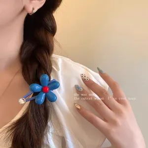 Blue flower hair clip detail shot, sweet style duckbill clip, trendy hair accessories.