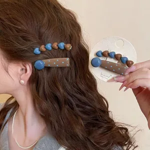 Retro sweet geometric hair clip set with blue heart and brown polka dot design for women.
