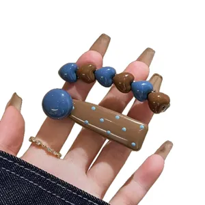 Cute heart shape hair clip set with blue and brown dotted design, perfect for sweet daily styling.