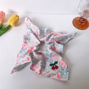 Cute pink floral scrunchie with lace heart and cherry charm for women hair styling.