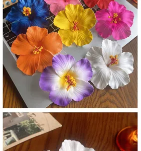 Colorful artificial hibiscus flower hair accessories detail view, vibrant Hawaiian floral pin.