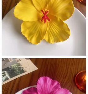 Detailed view of colorful artificial hibiscus flower hair clip accessories for Hawaiian styling.