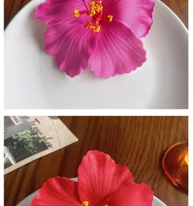 Detailed view of artificial hibiscus flower hair clip, vibrant Hawaiian floral accessory for styling.