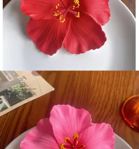 Detailed view of artificial hibiscus flower hair clip, vibrant floral hair accessory for summer.
