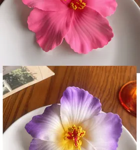 Detailed view of the artificial hibiscus hair clip, showing vibrant flower petals and stamen.