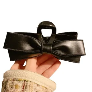 Korean PU leather bow hair claw clip, large black hair accessory for women styling and daily wear.