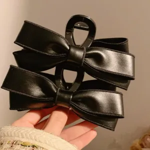 Korean style PU leather bow black hair claw clip, large size hair accessory for women main view.