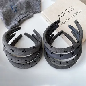 Detail view of Korean style wide brim grey bow and polka dot headbands for women hair accessories.