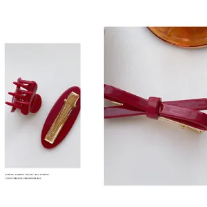 Burgundy bow hair clip and claw clip set, sweet retro design for festive hair styling.
