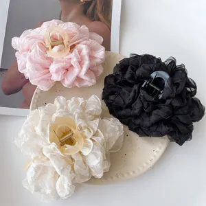 Detail shot of fluffy organza hair claw clip, featuring soft texture and elegant bow design.