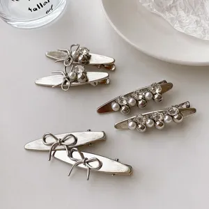 Silver metal hair clips set with bows, rhinestones and pearls. Korean sweet style side clips.