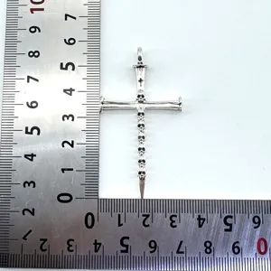 Detailed shot of vintage silver skull cross sword pendant, gothic style metal jewelry accessory.