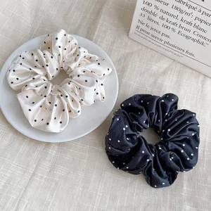 Satin polka dot hair scrunchies detail view, chic vintage hair accessories for women.