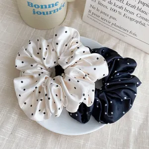Close-up detail of vintage French satin polka dot hair scrunchies, elegant hair tie accessories.
