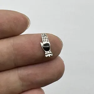 Miniature metallic hand nail art charm gothic style DIY jewelry accessory for creative manicures.