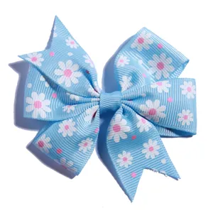 Close-up view of light blue ribbed grosgrain bow with white daisy print hair accessory.