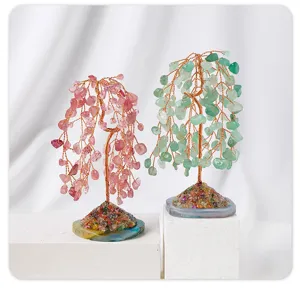 Detailed view of handmade crystal money trees with agate slice base in pink and green