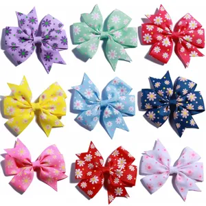 Set of colorful children's hair bows with daisy floral print and grosgrain ribbon texture