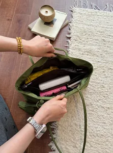 Detail view of green minimalist women tote bag showing large capacity and internal compartments.