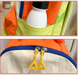 Detailed view of color block casual backpack, featuring vibrant orange, green and blue accents.