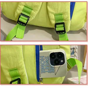 Detail view of Korean style casual color-block backpack strap buckle and side pocket design.
