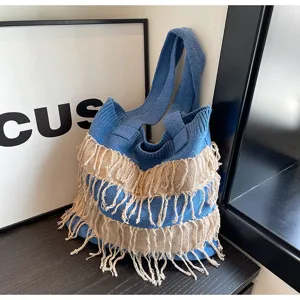 Stylish blue knitted shoulder bag with fringe, trendy casual tote for daily vacation use.
