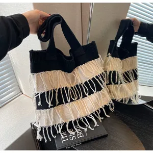 Black and white knit fringe tote bag detailed view, stylish casual shoulder bag for women.