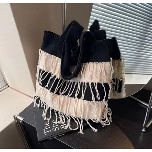 Black and white knit shoulder bag with stylish fringe details, perfect casual daily accessory.