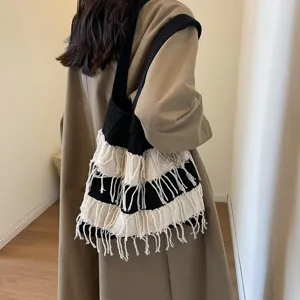 Detailed view of the black and white knit fringe shoulder bag for daily chic style.