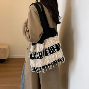 Stylish black and white knit tote bag with fringe tassels, large capacity shoulder bag.