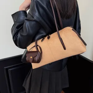 Chic suede shoulder bag for women with dark brown leather handles and a matching mini pouch.